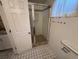 Bathroom features a new shower, with grab bars and sleek, decorative tile at 3770 S Ulster St, Denver, CO 80237