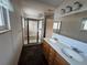 Bathroom featuring double sinks, a shower with glass door, and modern fixtures at 3770 S Ulster St, Denver, CO 80237