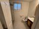 Bathroom features a new shower, toilet, and sink with sleek black and white tile at 3770 S Ulster St, Denver, CO 80237