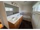 Bathroom featuring double sinks, tiled floors and tub at 3770 S Ulster St, Denver, CO 80237