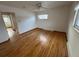 Bedroom featuring hardwood floors, a ceiling fan, and a large window for natural light at 3770 S Ulster St, Denver, CO 80237