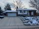 Charming single-Gathering home featuring a two-car garage and a well-maintained front yard in winter at 3770 S Ulster St, Denver, CO 80237