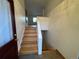 Entryway with hardwood stairs and a view into the home's interior at 3770 S Ulster St, Denver, CO 80237