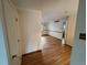 Hallway with wooden floors leading into dining and living area at 3770 S Ulster St, Denver, CO 80237