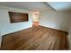 Spacious living room featuring wooden floors and a built-in bookshelf at 3770 S Ulster St, Denver, CO 80237