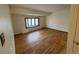 Bright living room with hardwood floors and a large bay window allowing ample natural light at 3770 S Ulster St, Denver, CO 80237