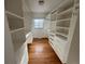 Walk-in closet with custom built-in shelving units at 3770 S Ulster St, Denver, CO 80237