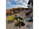 Landscaped backyard with a stone patio, balcony, and fall foliage views create an inviting outdoor space at 2430 Marlin Way, Castle Rock, CO 80109