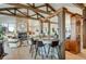 Stylish bar area with custom wood accents and seating, flowing into the living room with stone fireplace at 2430 Marlin Way, Castle Rock, CO 80109