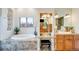 Elegant bathroom featuring a soaking tub, marble accents, and a vanity area with ample storage at 2430 Marlin Way, Castle Rock, CO 80109