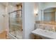 Clean bathroom with a glass-enclosed shower, vanity sink, and modern fixtures at 2430 Marlin Way, Castle Rock, CO 80109