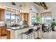 Eat-in kitchen features an island with bar seating and large windows showcasing scenic views at 2430 Marlin Way, Castle Rock, CO 80109