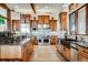 Spacious gourmet kitchen featuring custom cabinetry, stainless steel appliances, and stone countertops at 2430 Marlin Way, Castle Rock, CO 80109