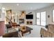 Inviting living room with a stone fireplace, large TV, and sliding glass doors with scenic views at 2430 Marlin Way, Castle Rock, CO 80109