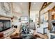 Cozy living room featuring a stone fireplace, hardwood floors, comfortable seating, and stylish accents at 2430 Marlin Way, Castle Rock, CO 80109