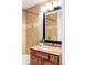 Well-lit bathroom featuring tiled shower and granite-topped vanity with modern faucet at 1610 Xanthia St, Denver, CO 80220