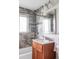 Inviting bathroom features tiled shower, granite vanity, and modern fixtures at 1610 Xanthia St, Denver, CO 80220