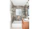Stylish bathroom features tiled shower, granite vanity, and modern fixtures at 1610 Xanthia St, Denver, CO 80220