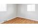 Empty bedroom with hardwood floors and natural light streaming through dual windows at 1610 Xanthia St, Denver, CO 80220