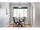 Cozy dining area featuring a round table, stylish chairs, and a bright window for natural light at 1610 Xanthia St, Denver, CO 80220