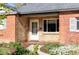 Close-up of the home's facade, featuring a walkway, front door and brick and stone design elements at 1610 Xanthia St, Denver, CO 80220