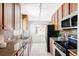 Functional kitchen featuring ample wood cabinets, granite countertops, stainless steel appliances and a mosaic backsplash at 1610 Xanthia St, Denver, CO 80220