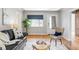 Stylish living room featuring hardwood floors, a comfortable couch, and natural light from the window at 1610 Xanthia St, Denver, CO 80220