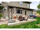 Outdoor patio with comfortable seating, a grill, and an umbrella, perfect for relaxing and enjoying the backyard at 14200 W 86Th Pl, Arvada, CO 80005