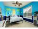 Whimsical bedroom with bright blue walls, palm tree decorations, and a comfortable bed, perfect for a room at 14200 W 86Th Pl, Arvada, CO 80005