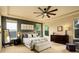 Tranquil bedroom with plush carpeting, tray ceiling, and large windows, offering a serene retreat at 14200 W 86Th Pl, Arvada, CO 80005