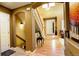 Inviting entryway featuring hardwood floors, staircase, and neutral color palette creating a warm and welcoming atmosphere at 14200 W 86Th Pl, Arvada, CO 80005