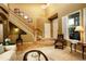 Elegant foyer featuring a staircase, hardwood floors, and a high ceiling, creating a grand entrance at 14200 W 86Th Pl, Arvada, CO 80005