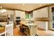 Well-lit kitchen with a center island, stainless steel appliances, and white cabinetry for ample storage at 14200 W 86Th Pl, Arvada, CO 80005