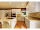 Modern kitchen features stainless steel appliances, white cabinets, and a stylish center island with barstool seating at 14200 W 86Th Pl, Arvada, CO 80005