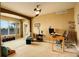 Comfortable living room bathed in natural light, with a ceiling fan and neutral tones, ideal for relaxing or entertaining guests at 14200 W 86Th Pl, Arvada, CO 80005