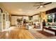 Spacious living room with hardwood floors, large windows, and an open layout connecting to the kitchen and dining area at 14200 W 86Th Pl, Arvada, CO 80005