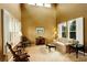 Bright living room with tall ceilings, plantation shutters, neutral tones, and ample natural light at 14200 W 86Th Pl, Arvada, CO 80005