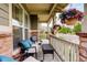 Inviting porch with comfortable seating, hanging plants, and a view of the neighborhood, offering a cozy outdoor space at 14200 W 86Th Pl, Arvada, CO 80005