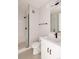 Contemporary bathroom featuring glass shower, white vanity with black fixtures, and sleek tiling throughout at 8260 E 36Th Ave # 30, Denver, CO 80238