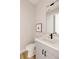 Powder room with gray vanity, white countertop, black faucet, and wood look flooring at 8260 E 36Th Ave # 30, Denver, CO 80238