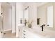 Modern bathroom features double sinks, white cabinets, and stylish fixtures at 8260 E 36Th Ave # 30, Denver, CO 80238