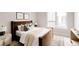 Bright bedroom featuring a brown upholstered bed frame, and a cream knitted throw blanket at 8260 E 36Th Ave # 30, Denver, CO 80238