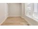 Bright bedroom featuring wood-look flooring, ample natural light from a large window, and a neutral color palette at 8260 E 36Th Ave # 30, Denver, CO 80238