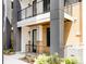 Modern townhome exterior features brick accents, black railings, and a covered porch, blending textures and style at 8260 E 36Th Ave # 30, Denver, CO 80238