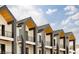 New construction home featuring a black metal roof, wood accents, and gray posts at 8260 E 36Th Ave # 30, Denver, CO 80238