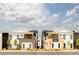 Contemporary townhomes showcasing modern architecture with brick accents and well-maintained landscaping at 8260 E 36Th Ave # 30, Denver, CO 80238