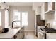 Bright kitchen features white cabinets, modern appliances, and a large center island with quartz countertops at 8260 E 36Th Ave # 30, Denver, CO 80238