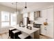 Stylish kitchen featuring stainless appliances, quartz countertops, a center island, and globe pendant lighting at 8260 E 36Th Ave # 30, Denver, CO 80238