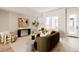 Inviting living room with hardwood floors, a comfortable olive couch, and plenty of natural light at 8260 E 36Th Ave # 30, Denver, CO 80238
