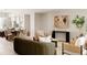 Bright, open-concept living room and kitchen featuring modern decor and hardwood flooring at 8260 E 36Th Ave # 30, Denver, CO 80238